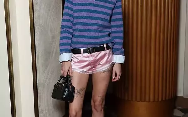 Emma Corrin Showcases Intricate Leg Tattoos in Pink Hotpants at Miu Miu Paris Fashion Week Party